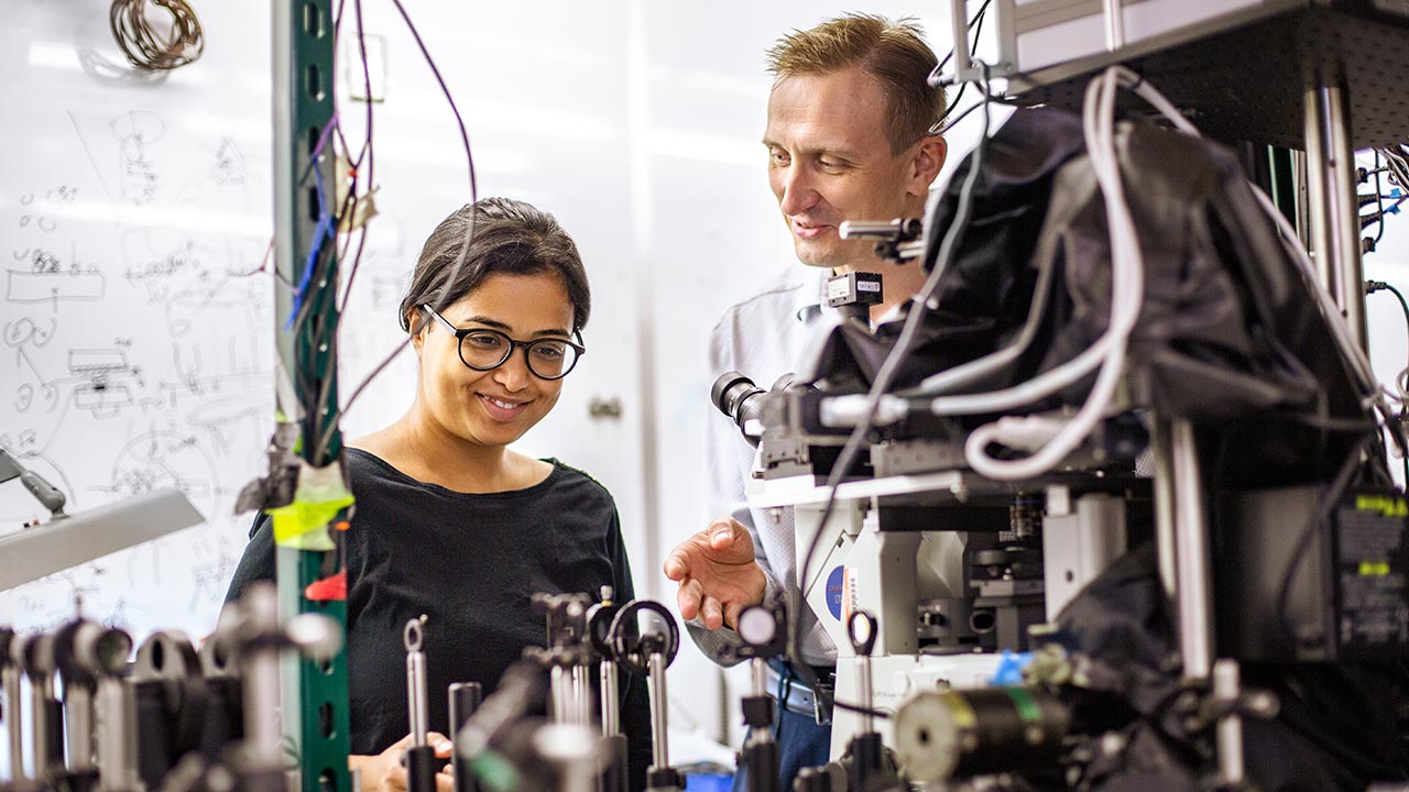Researchers work on optics in UTD on-campus lab.
